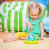 BRIGHT STARTS Zenélő, világító játék Press & Glow Spinner 6hó+