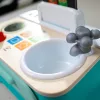 BABY EINSTEIN Zenei Játék Magic Touch Kitchen™ Pretend to Cook HAPE 9hó+